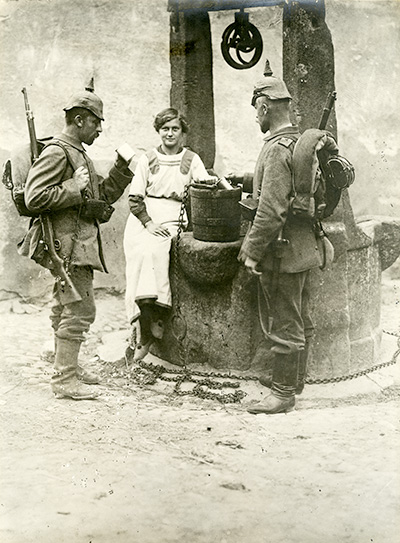 Soldados alemanes en un pozo junto a una joven
